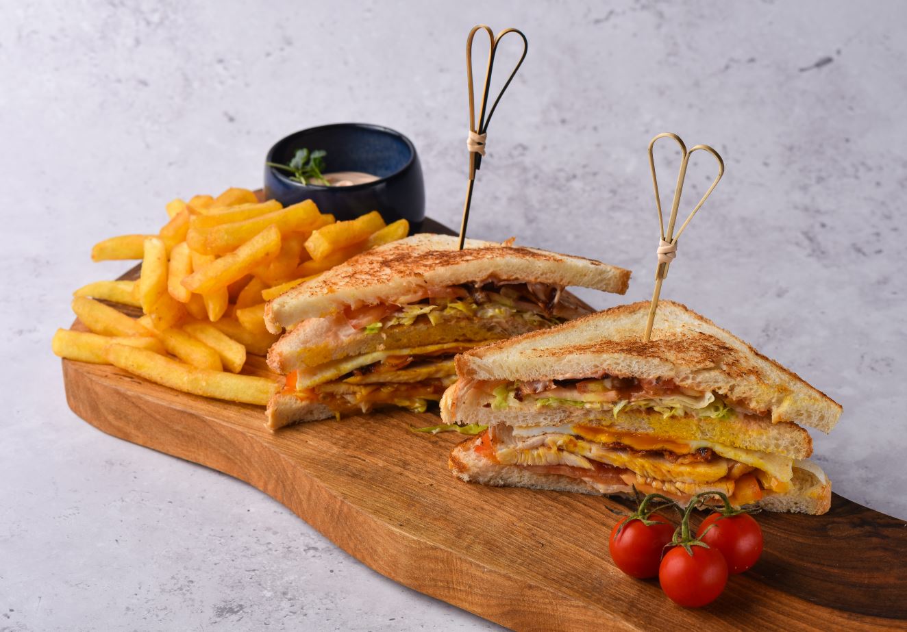 Club sandwich with chicken, bacon and potatoes
