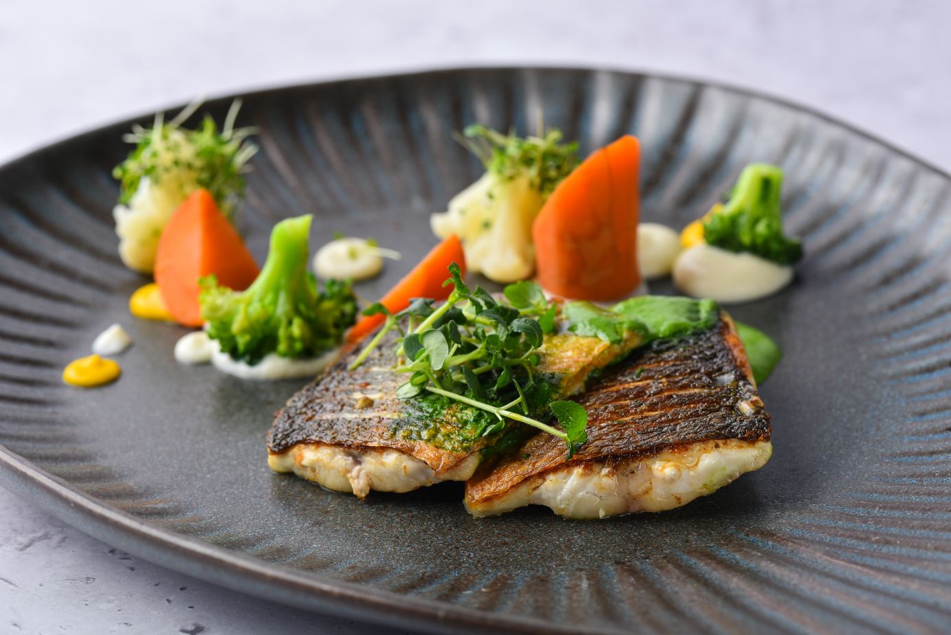 Adriatic sea-bass fillet with celery puree, spinach cream and vegetables